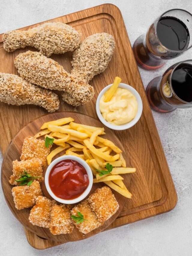 flat-lay-fried-chicken-legs-nuggets-with-fizzy-drinks-french-fries_23-2148646614